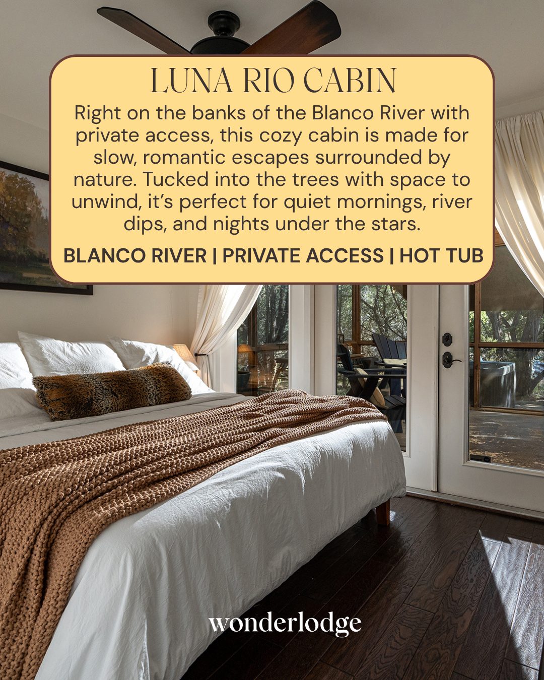 Bedroom at Luna Rio Cabin, a romantic cabin on the Blanco River in Wimberley, TX, with French doors to a private hot tub